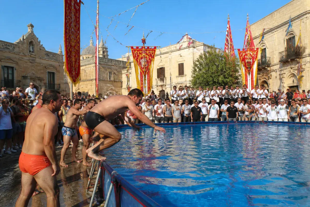 Maltese Government Declares Mandatory Swimming Competitions at Every Feast to Drown Out Band Marches